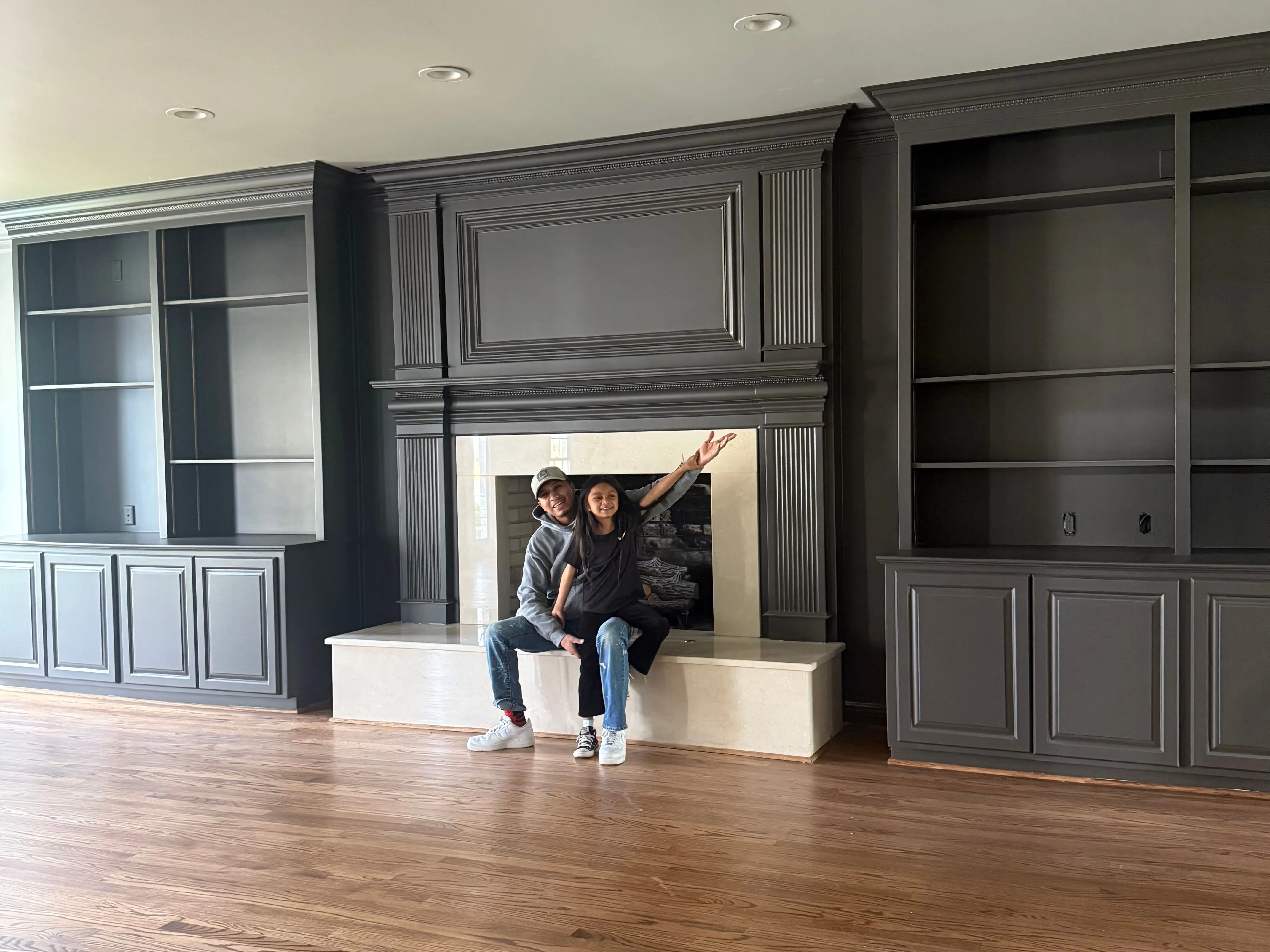 Saul Velasquez and his daughter Ivy, the namesake of Ivy's Painting Services LLC, in a freshly painted kitchen.